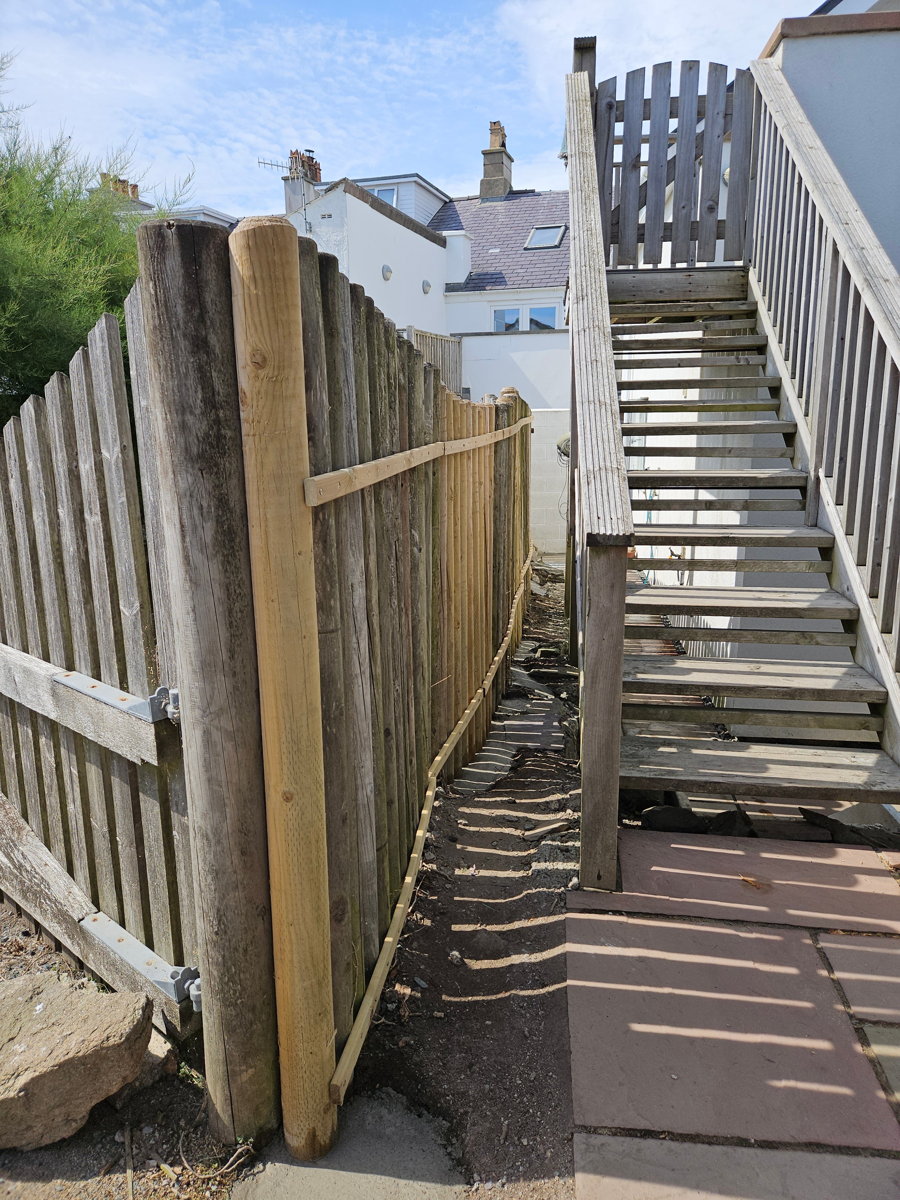 Completed timber fence repair with replacement posts in Anglesey