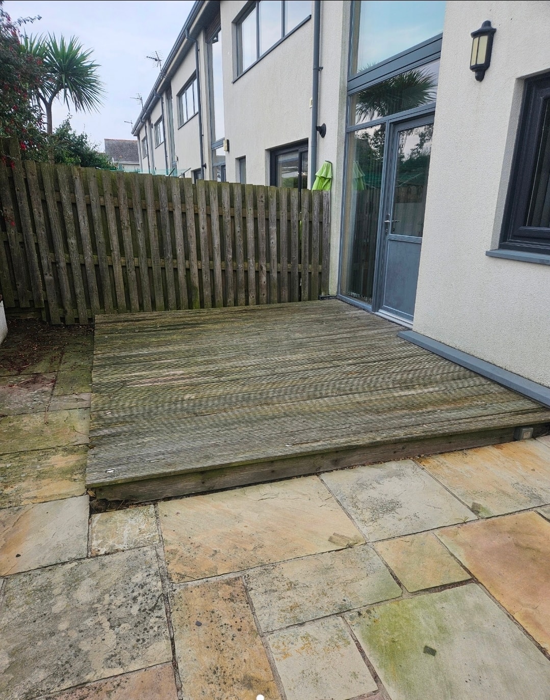 Old decking before replacement with Indian sandstone in Rhosneigr, Anglesey